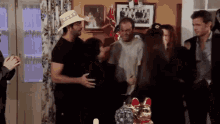 a man wearing a cowboy hat is hugging another man