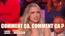 a woman is sitting in front of a crowd with the words comment ca comment ca