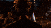 a woman in a knight 's outfit is surrounded by other people