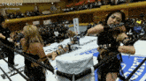 a woman in a wrestling ring with a sign that says stardom on it