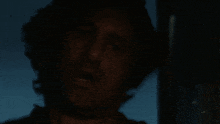a dark room with a light shining through a hole in the ceiling