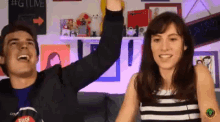 a man and woman are raising their arms in the air