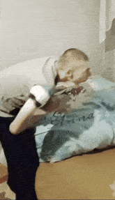 a man laying on a bed with a pillow that says anna