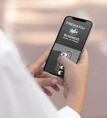 a person holding a cell phone that says firewatch business on it