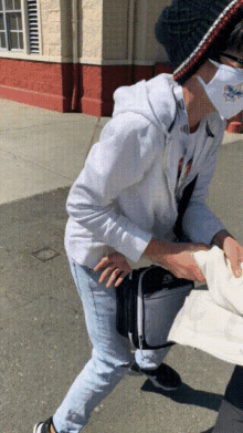 a person wearing a white face mask with a picture of a dolphin on it
