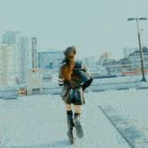 a woman standing on a balcony looking at the city