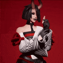 a woman with horns on her head is wearing a white and red outfit