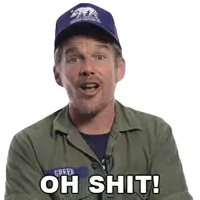 a man wearing a green jacket and a blue hat says " oh shit "