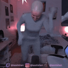 a person in a bodysuit is standing in a room with a bed and a microphone .