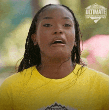 a woman is wearing a yellow shirt that says canada 's ultimate challenge on it