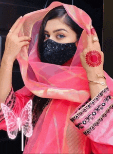 a woman wearing a pink scarf and a black mask