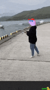 a person with a cartoon character on their head holding a fishing rod