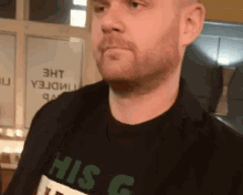 a man wearing a shirt that says his g