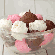 a glass bowl filled with pink white and chocolate marshmallows with easy plus written on the bottom