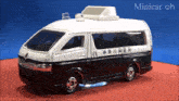 a black and white toy van with asian writing on the side