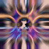 a blurred image of a person 's face with a purple and blue center