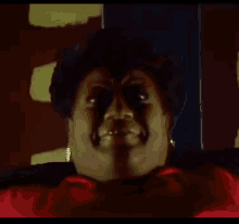 a close up of a woman 's face with a red shirt