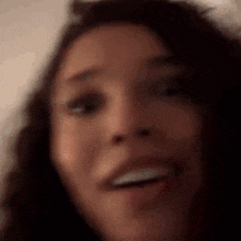 a close up of a woman 's face smiling .