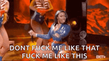 a woman is dancing on a stage while holding a microphone and says `` dont fuck me like that fuck me like this ''