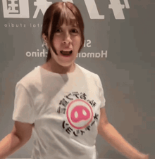 a woman wearing a white t-shirt with a pig face on it