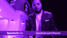 an advertisement for spectrum one shows a man in a suit and tie