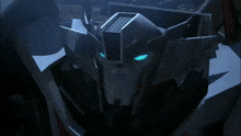 a close up of a robot 's head with blue eyes