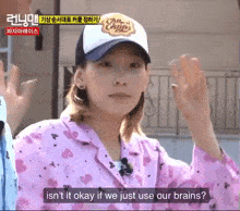 a woman wearing a chupa chups hat says " isn t it okay if we just use our brains "