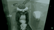 a person wearing a bunny costume is sitting on a toilet .