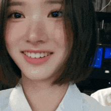 a close up of a woman 's face with a smile on her face .