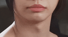a close up of a woman 's face with a red lip