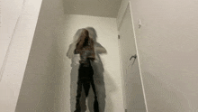 a shadow of a woman is cast on a wall