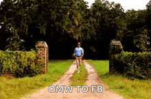 a man is running down a dirt road with the words omw to fb written on it .