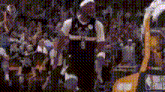 a basketball player kneeling down in front of a crowd