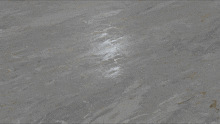 a close up of a gray surface with a few lines on it