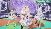 three anime girls are dancing on a stage with a sign above them that says ' a '