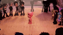 a group of cartoon characters are dancing on a stage in a room .