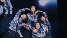 a group of girls are posing for a picture and one of them is wearing a shirt that says ' i love you '