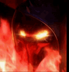 a close up of a person 's face with glowing eyes surrounded by red flames .