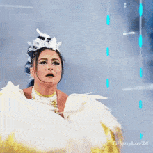 a woman in a white and gold feathered costume with tiffanyluv24 written on the bottom right
