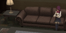 a man and a woman are standing next to a couch in a living room .