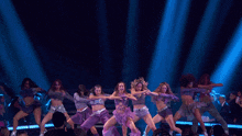 a woman in a purple dress is dancing and making a funny face