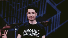 a man wearing a black anohni hopelessness shirt