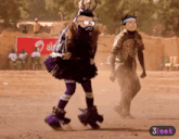 a man in a purple dress is dancing in front of a sign that says airtel