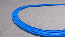 a toy train is going down a track on a carpet .