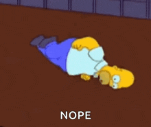homer simpson is laying on his stomach on the floor and says nope .