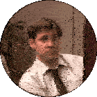 a man in a white shirt and tie looks at something