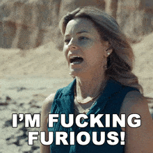 a woman with her mouth open and the words i 'm fucking furious behind her
