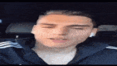 a man wearing ear buds is sitting in a car