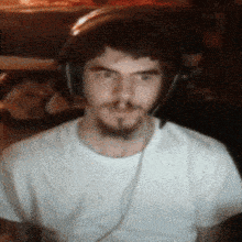 a man wearing headphones looks at the camera