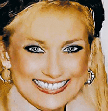 a close up of a woman 's face with a large smile